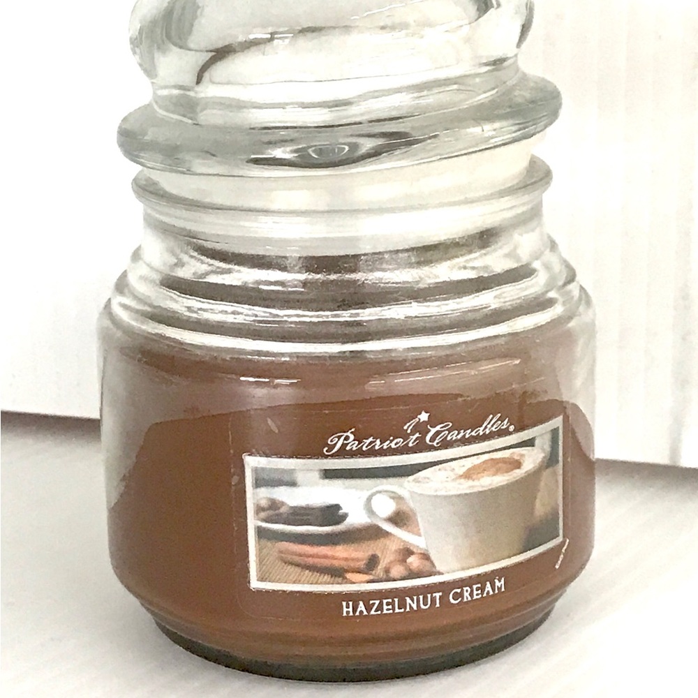 Hazelnut cream scented candle in a glass jar with lid  lighted once medium 8 oz